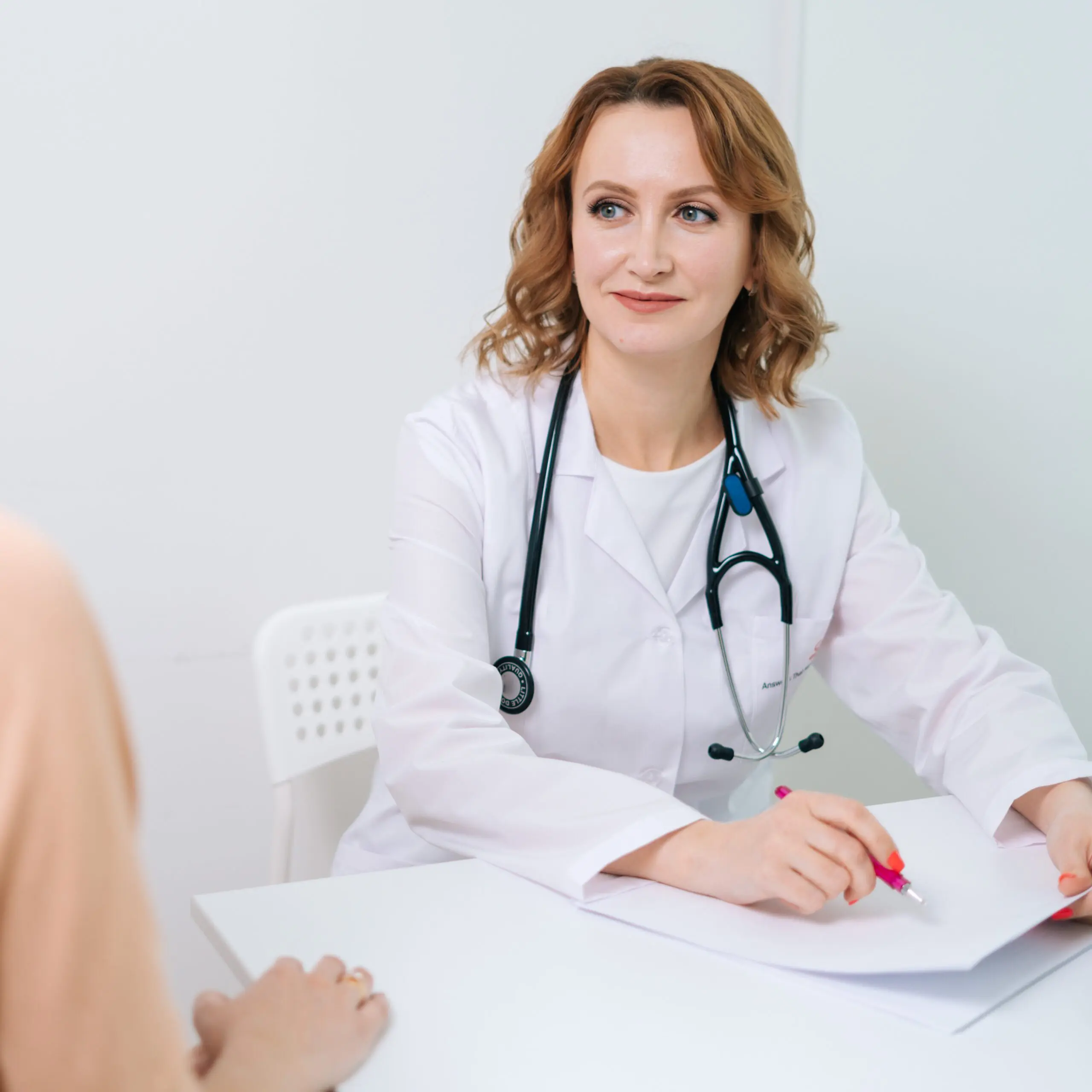 bigstock-Blonde-Doctor-Wearing-White-La-381142034