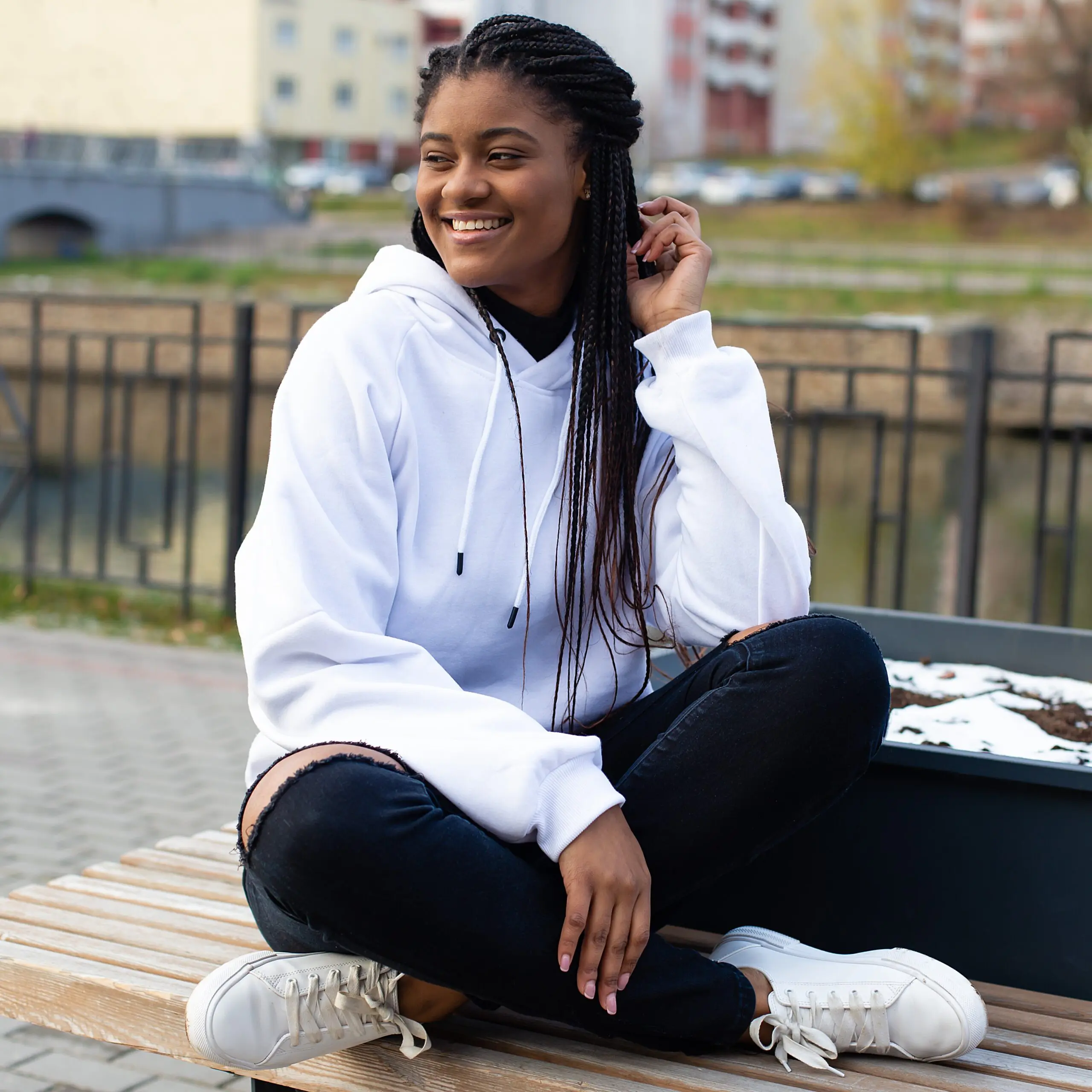 The Happy African American Woman In The Park On A Bench